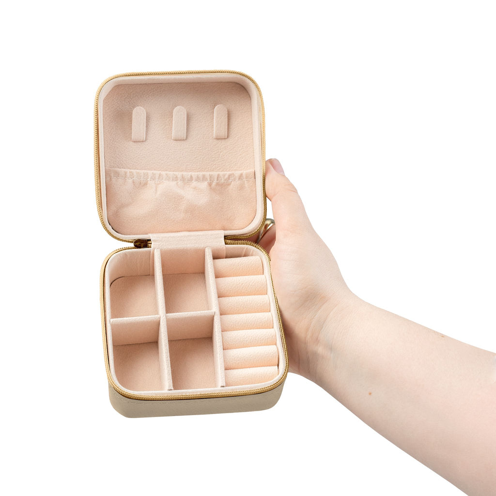 Salt & Starlight jewelry travel case in soft gold, open view showing compartments and ring rolls