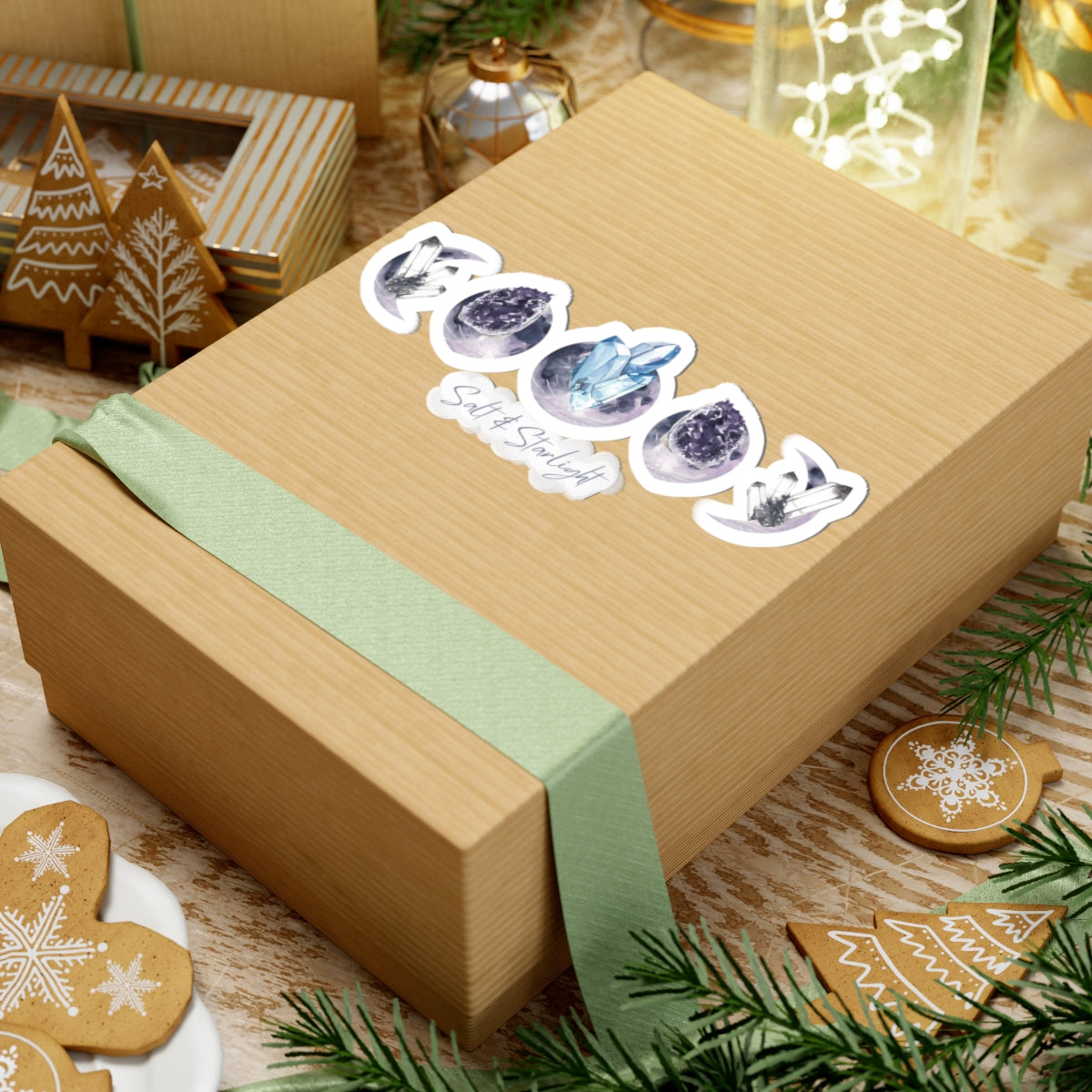 Salt & Starlight kiss-cut sticker with crystal moon phase design, shown on a gift box, close-up view