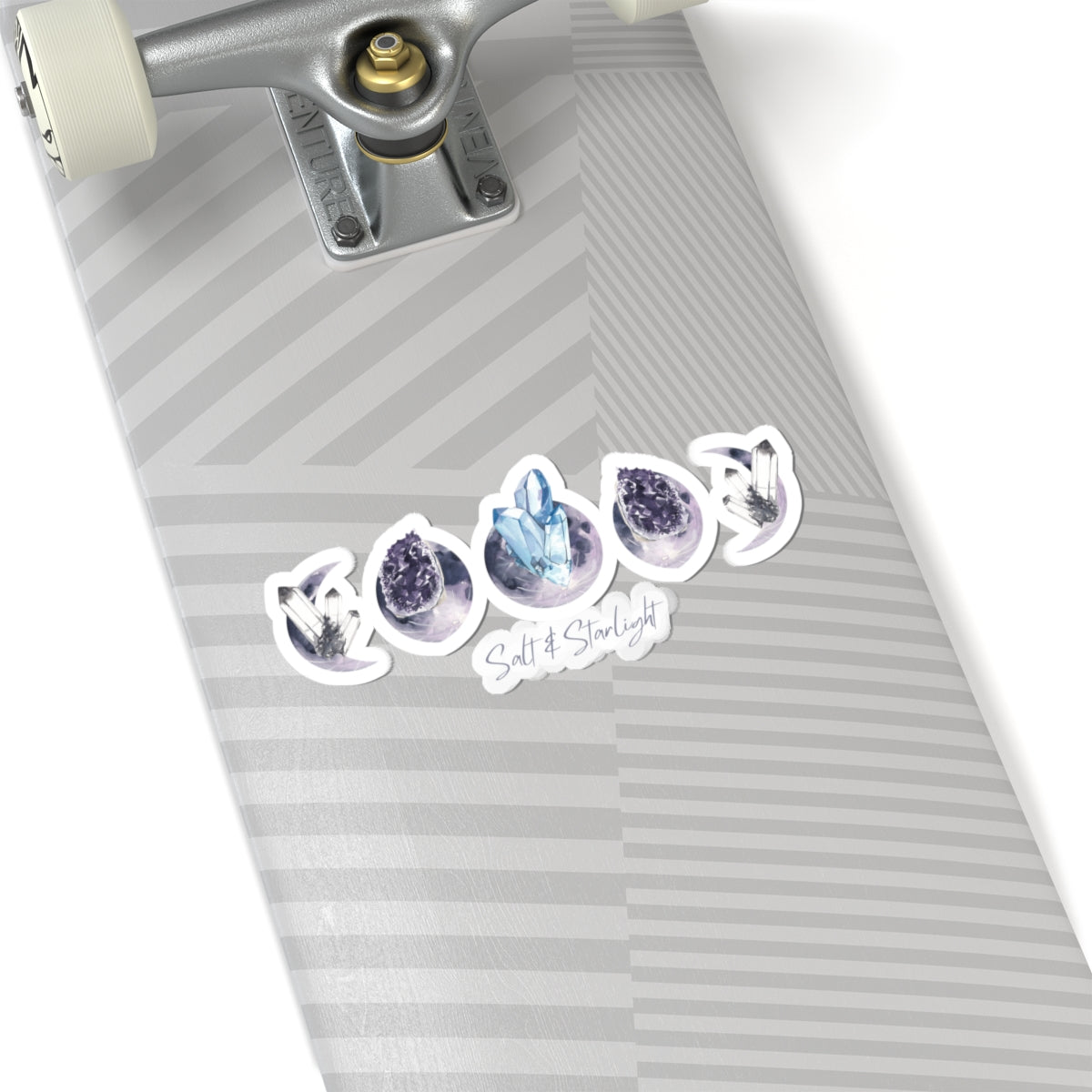 Salt & Starlight kiss-cut sticker with crystal moon phase design, shown on a longboard