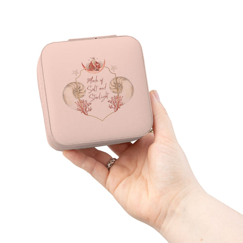 Salt & Starlight jewelry travel case in pink, held in hand showing the shell and coral design