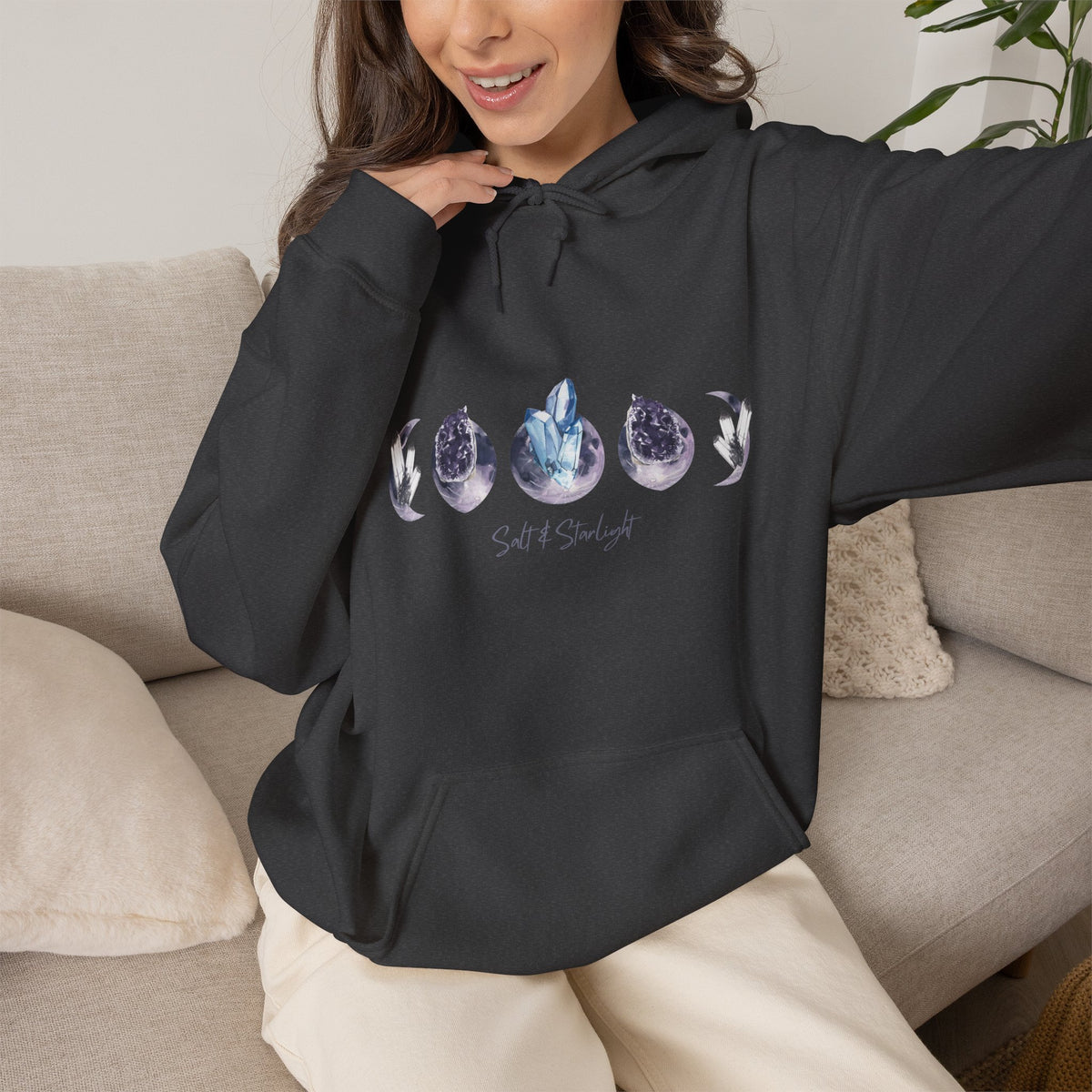 Salt & Starlight hooded sweatshirt in dark heather, worn by a model showing the crystal moon phase design