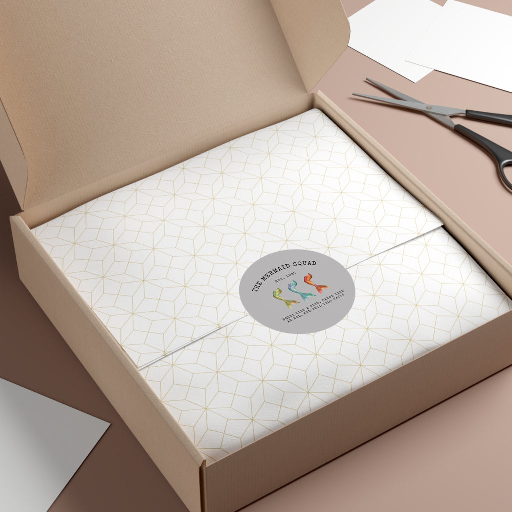 The Mermaid Squad round vinyl sticker in grey, shown on a gift box