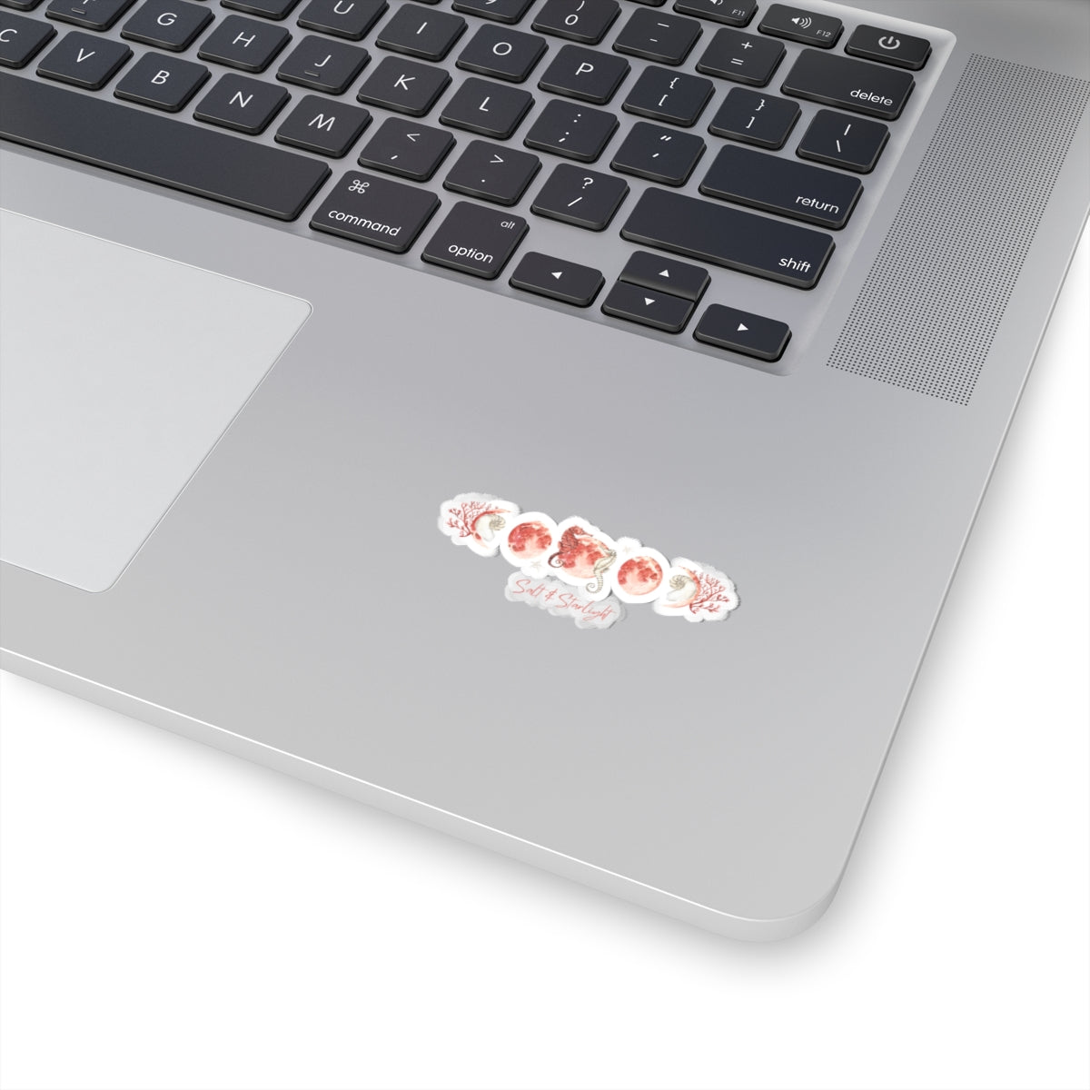 Salt & Starlight kiss-cut sticker with seahorse and coral moon phase design, shown on a laptop, small size