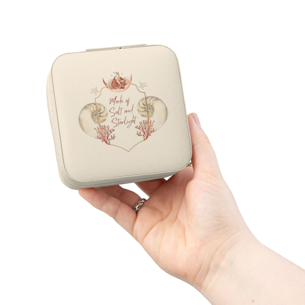 Salt & Starlight jewelry travel case in ivory, held in hand showing the shell and coral design