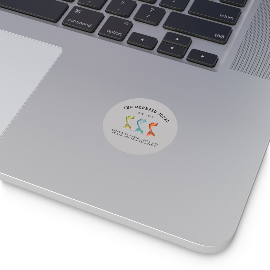 The Mermaid Squad round vinyl sticker in grey, shown on a laptop, alternate view