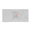 The Mermaid Squad beach towel, flat lay view with three colorful mermaid tails design