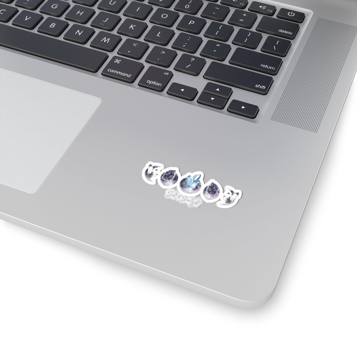 Salt & Starlight kiss-cut sticker with crystal moon phase design, shown on a laptop, small size