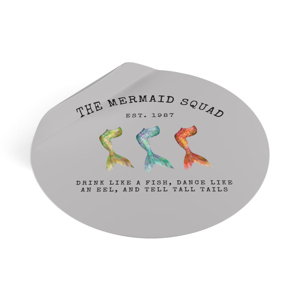 The Mermaid Squad round vinyl sticker in grey, peeling view showing the sticker lifting at the edge