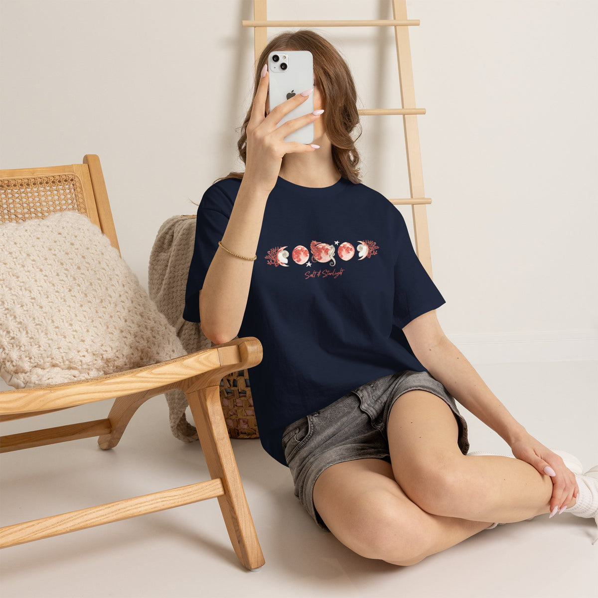 Salt & Starlight heavy cotton tee in navy, worn by a model showing the coral moon phase design