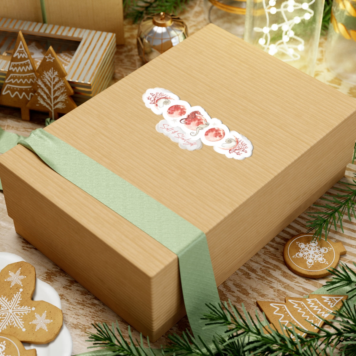 Salt & Starlight kiss-cut sticker with seahorse and coral moon phase design, shown on a gift box, alternate view